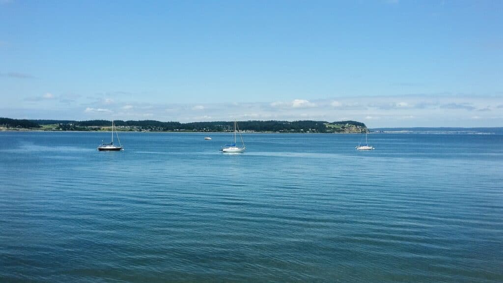 Whidbey Island girls’ getaway water view Sailboats on calm blue water during a Whidbey Island girls’ getaway
