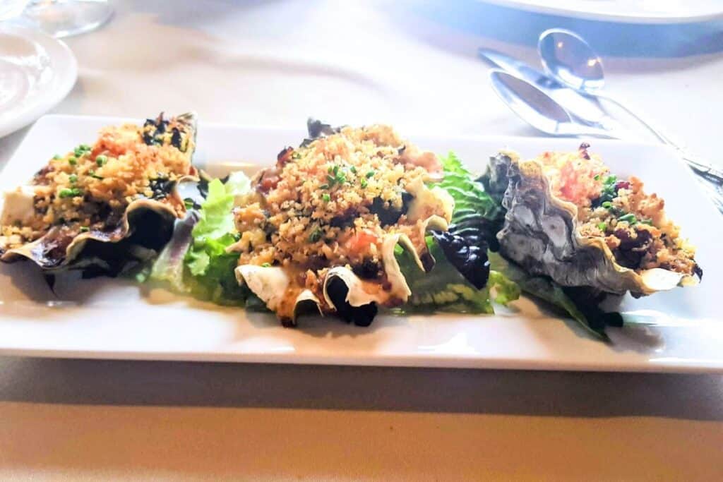 A plate with 3 baked oysters at The Oyster Bar on Chuckanut Drive in Western Washington