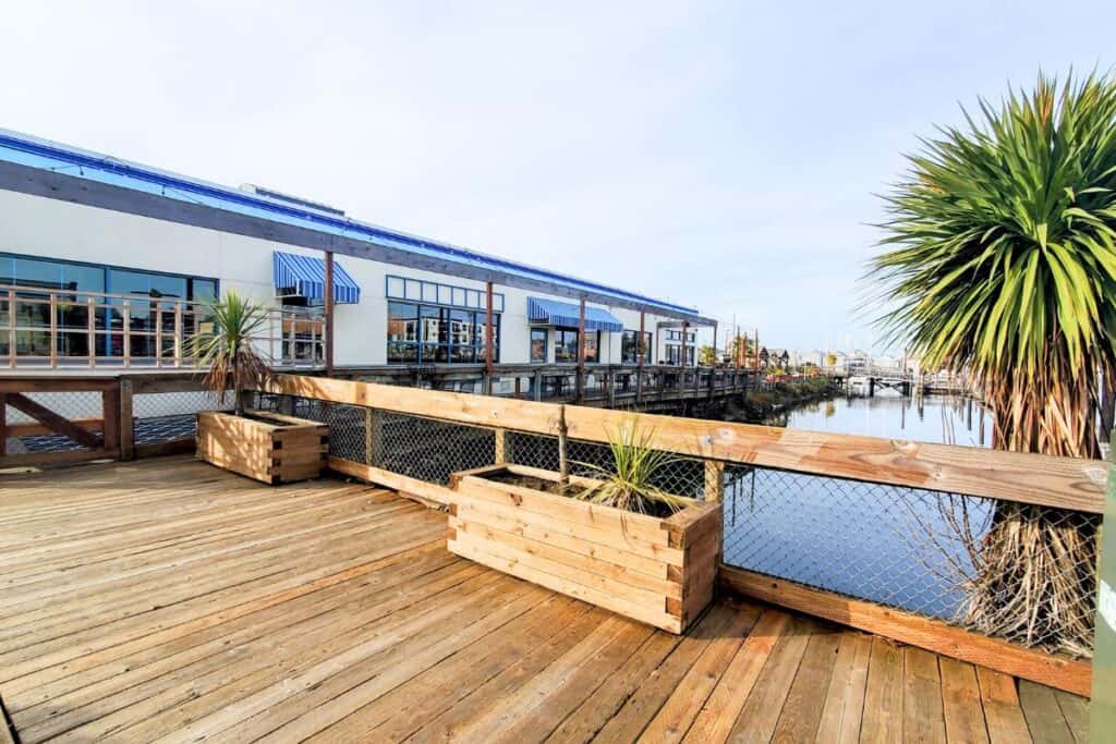 Waterfront deck outside Olympia Oyster House in Olympia, Washington, with marina views and outdoor seating.
