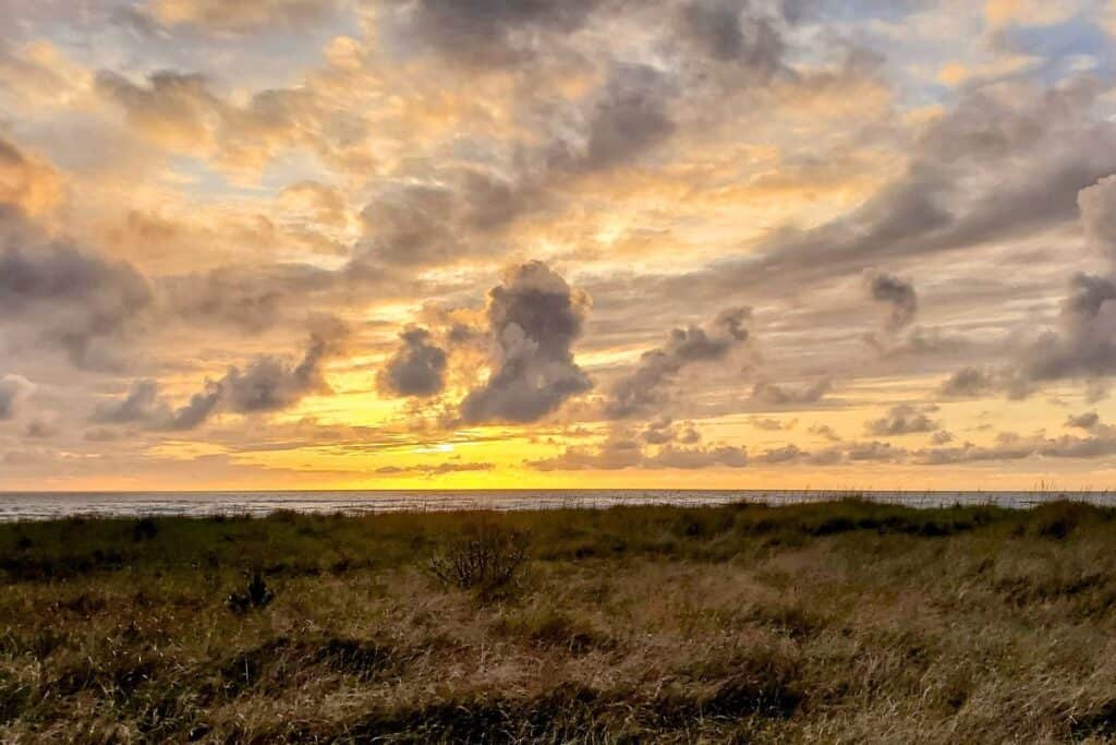 Cloudy, golden sunset on the Long Beach Peninsula in Washington State.