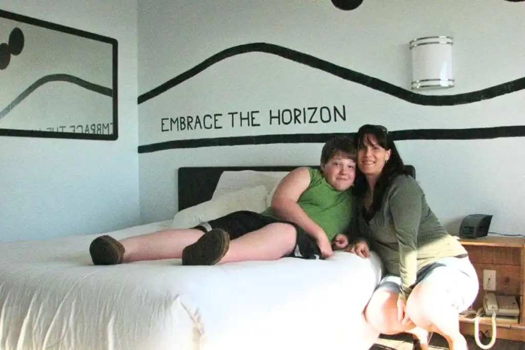 Mother and teenage son sitting together in a room at the Adrift Hotel in Long Beach, Washington