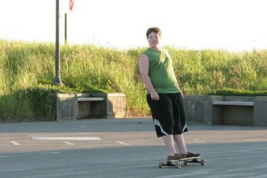 Teen boy riding a longboard during a family trip to Long Beach, Washington