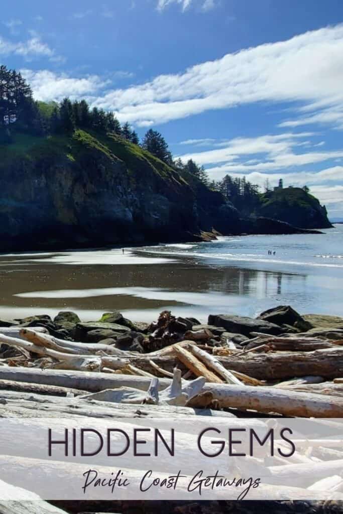 Cape Disappointment State Park | PNW Travel Girl A view of the lighthouse on the cliffs from the sandy, driftwood beach at Cape Disappointment State Park