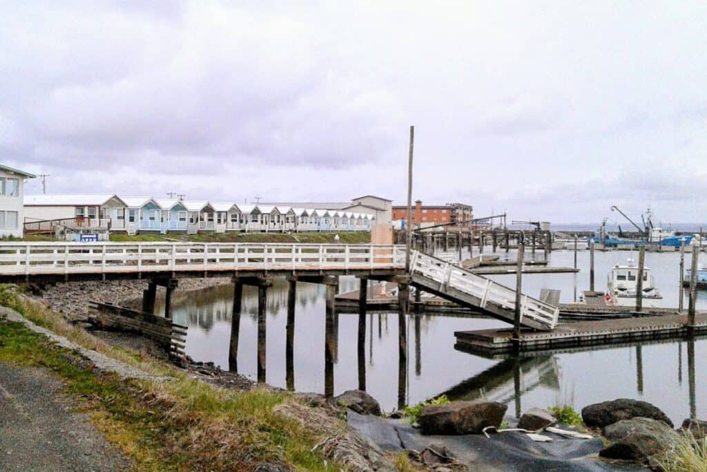 Westport Washington marina with wooden dock, fishing boats, and cottages along the harbor.