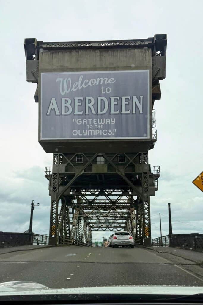 Driving into Aberdeen Washington across the historic bridge Welcome to Aberdeen bridge sign crossing into Aberdeen, Washington on a cloudy day.