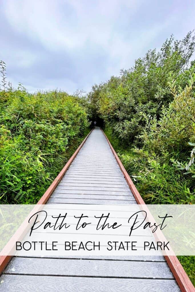 A long, weathered wooden boardwalk stretches into the distance, framed by lush green coastal brush and a soft overcast sky at Bottle Beach State Park. A clean white semi-transparent overlay at the bottom features the text "Path to the Past" in a decorative script and "BOTTLE BEACH STATE PARK" in a bold, modern font.