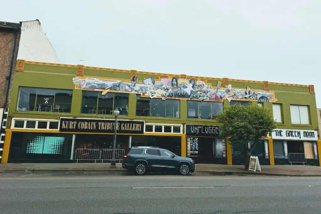 Kurt Cobain Tribute Gallery Storefront and Mural Wide exterior view of the Kurt Cobain Tribute Gallery and music museum building in downtown Aberdeen Washington with a large rock music mural.