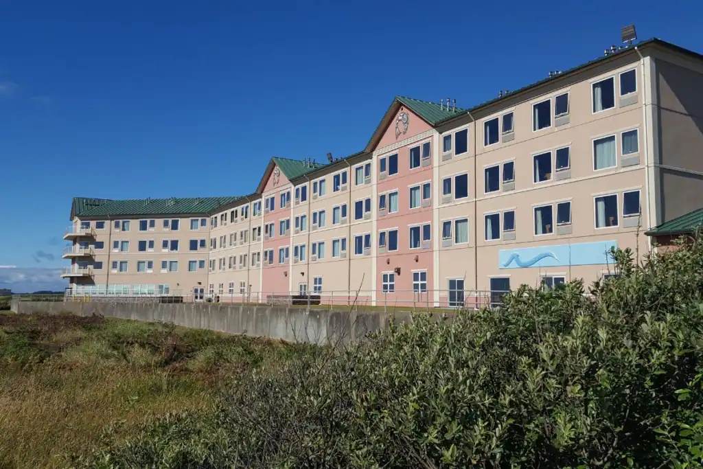 Quinault Beach Resort and Casino Exterior Ocean Shores Washington The exterior building facade of Quinault Beach Resort and Casino under a clear blue sky, viewed from the sandy dune path in Ocean Shores WA.