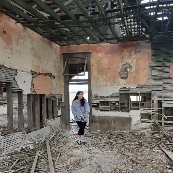 Mandy from PNW Travel Girl exploring an abandoned historic building on a ghost town trip