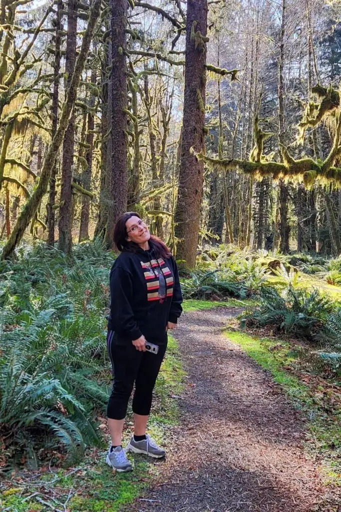 Mandy from PNW Travel Girl standing on a forest trail in the Pacific Northwest