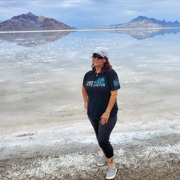 Mandy from PNW Travel Girl standing at the Utah Salt Flats during a road trip