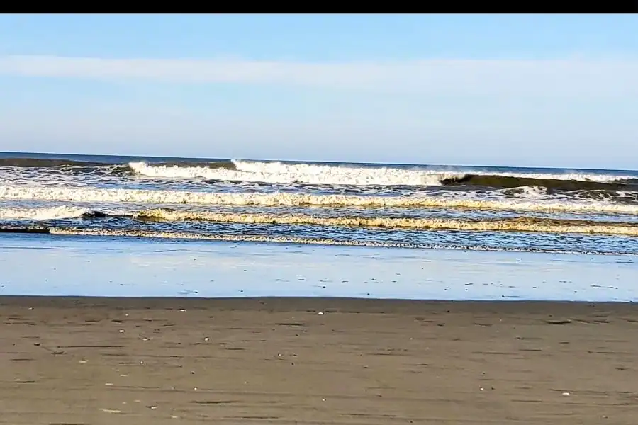 Wide sandy beach with waves rolling in at Ocean Shores, Washington