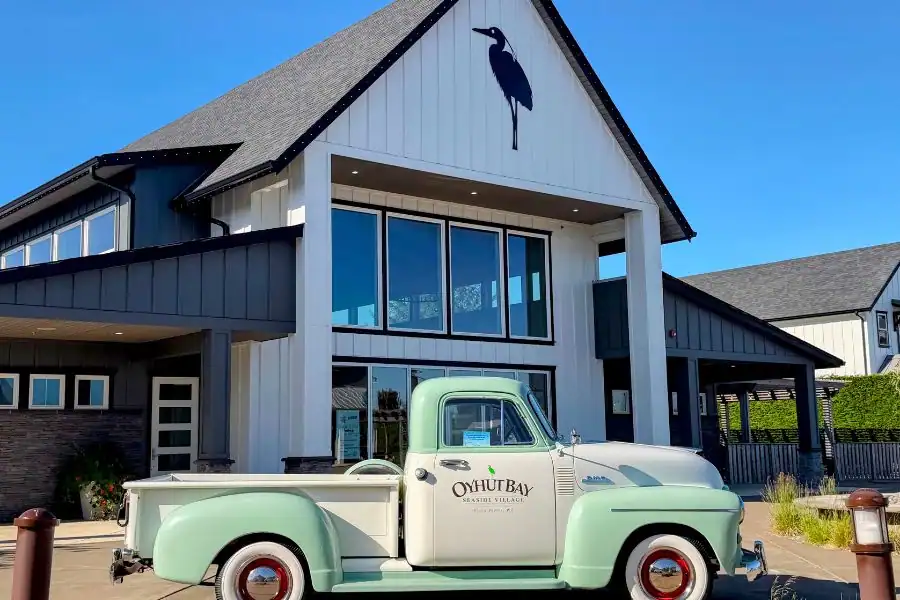Vintage Oyhut Bay Seaside Village truck parked in front of a building in Ocean Shores, Washington