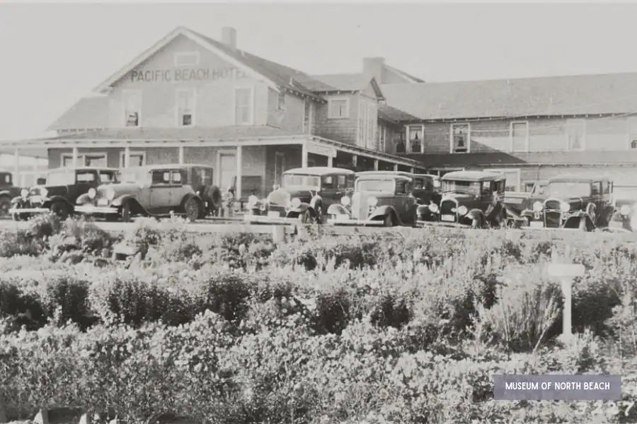 Historic Pacific Beach Hotel with early automobiles parked outside in Pacific Beach, Washington