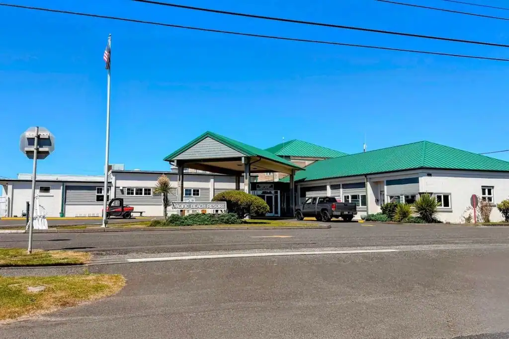 Main building at Navy Getaways Pacific Beach with flags flying outside