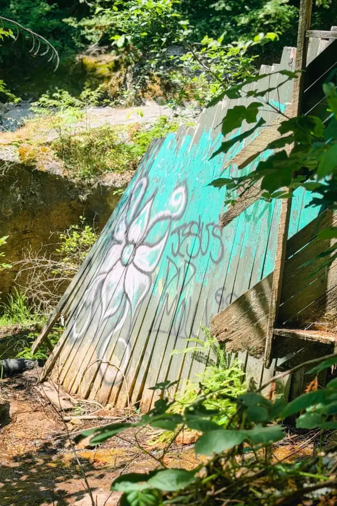 Old Green River Gorge Resort remnants along the trail Weathered turquoise wooden wall with graffiti beside the Green River Gorge trail