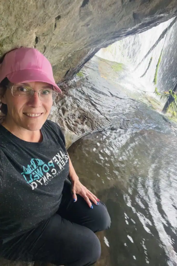 Sitting in the hidden waterfall pool at Green River Gorge Woman sitting in the cold sandstone pool behind a waterfall at Green River Gorge near Enumclaw, Washington